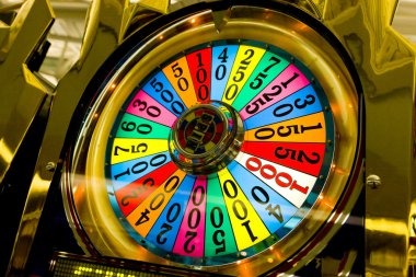 Galactic Gems slot game interface showing five reels with cosmic symbols and payout table